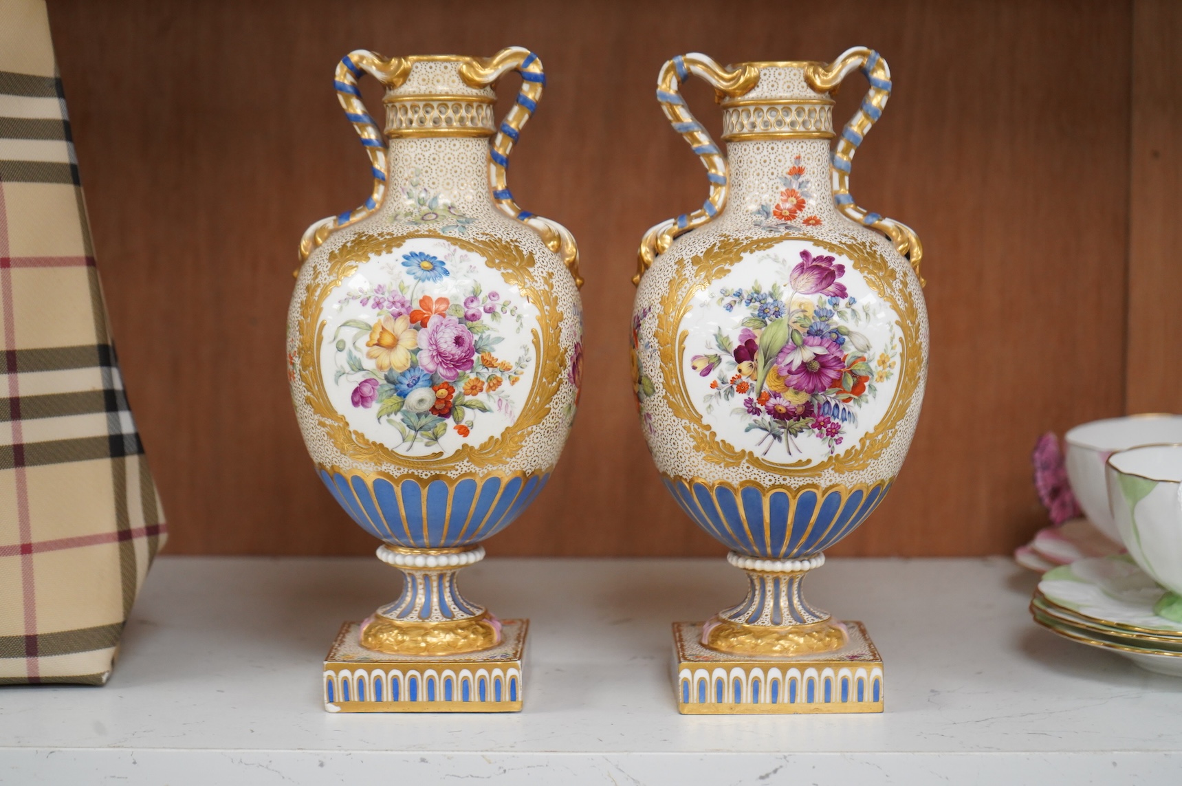 A pair of 19th century Sevres style porcelain vases hand painted with flowers, 22cm high